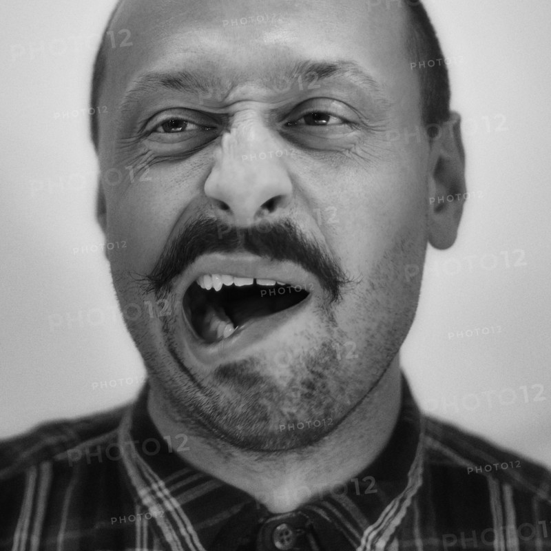 Close up of Caucasian man grimacing