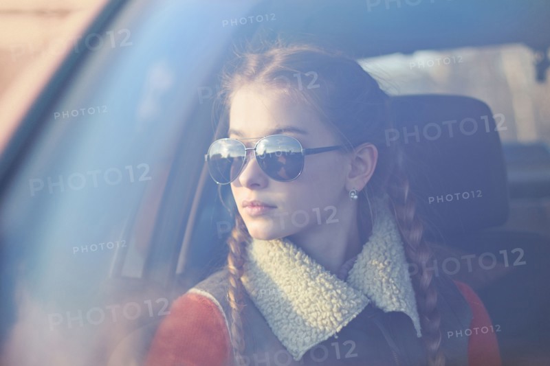 Caucasian teenage girl sitting in car