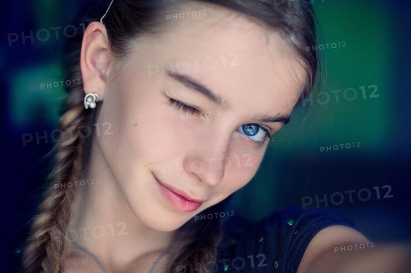 Caucasian teenage girl winking