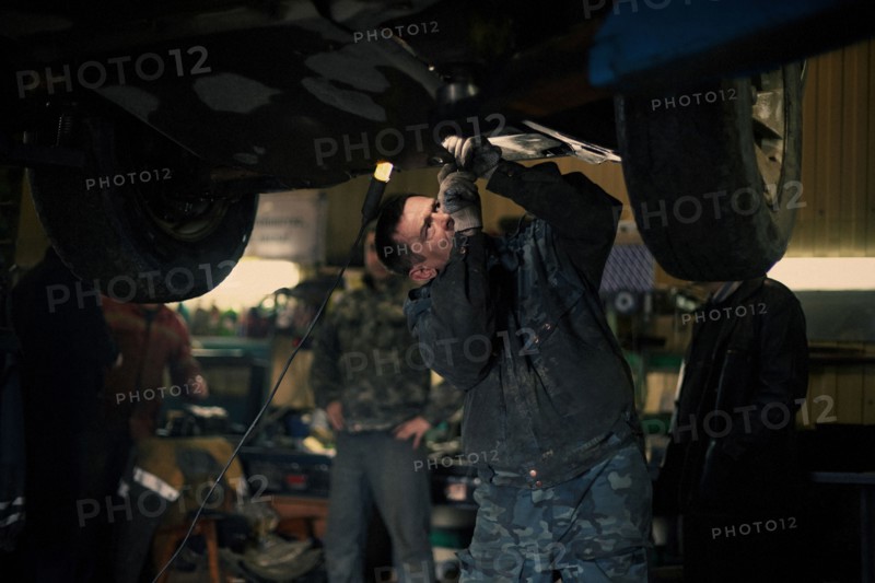 Caucasian mechanic fixing car