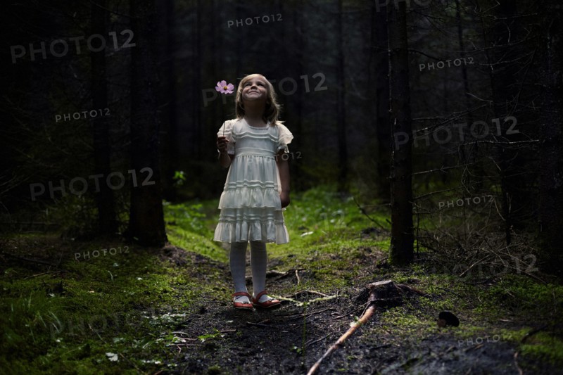 Caucasian girl standing in forest
