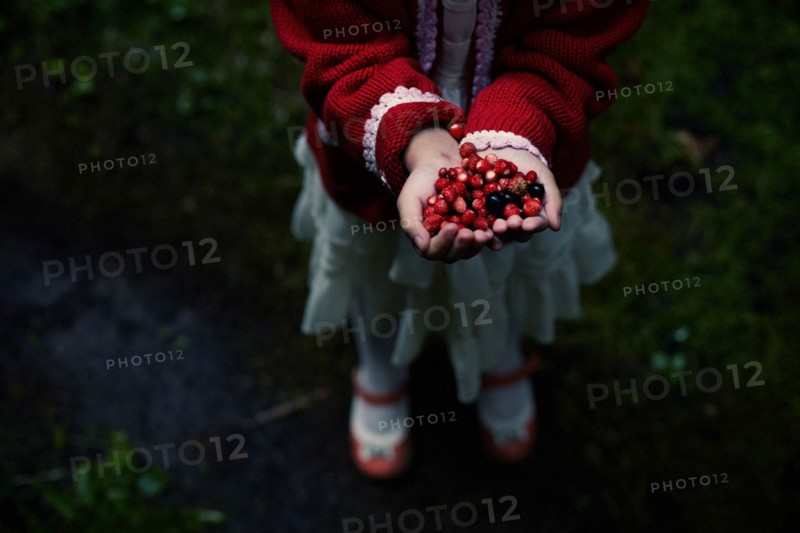 Caucasian girl gathering berries