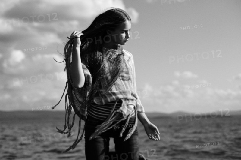 Caucasian girl standing over lake