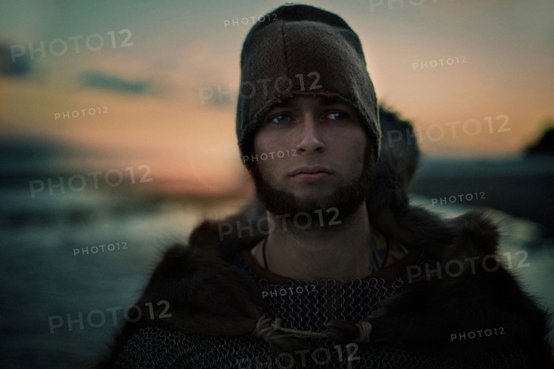 Caucasian man wearing hat and cape