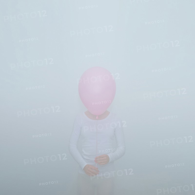 Caucasian teenage girl holding balloon