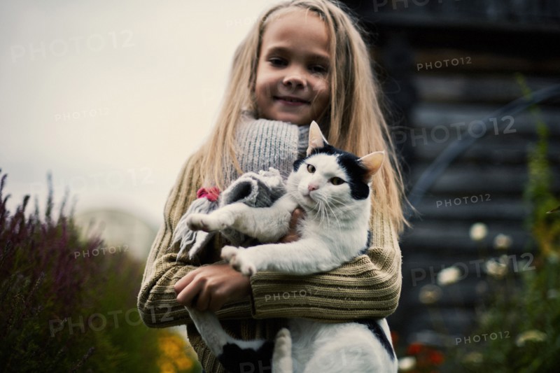 Caucasian girl holding cat