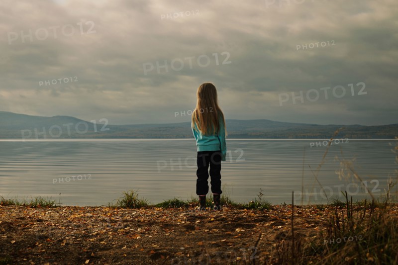 Caucasian girl standing at lake