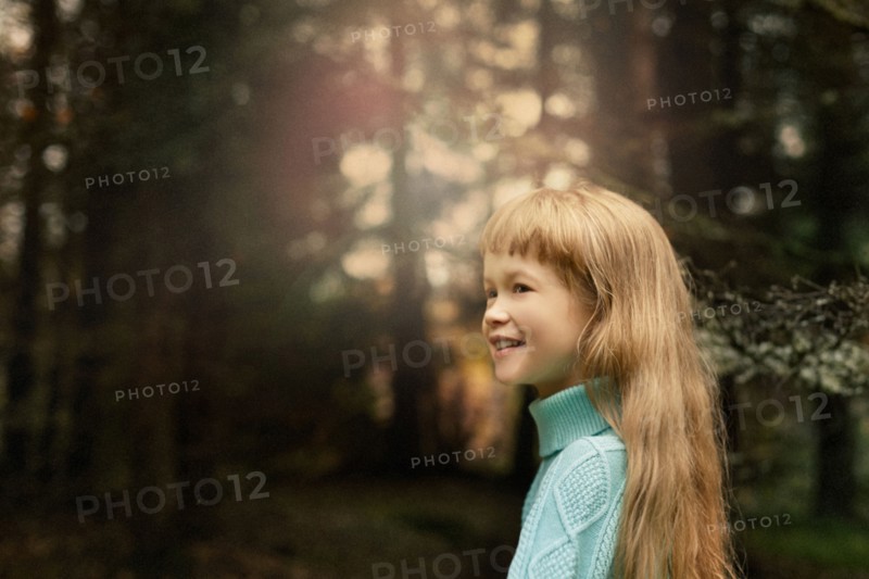 Caucasian girl walking in forest
