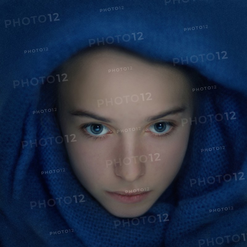 Caucasian teenage girl wrapped in scarf