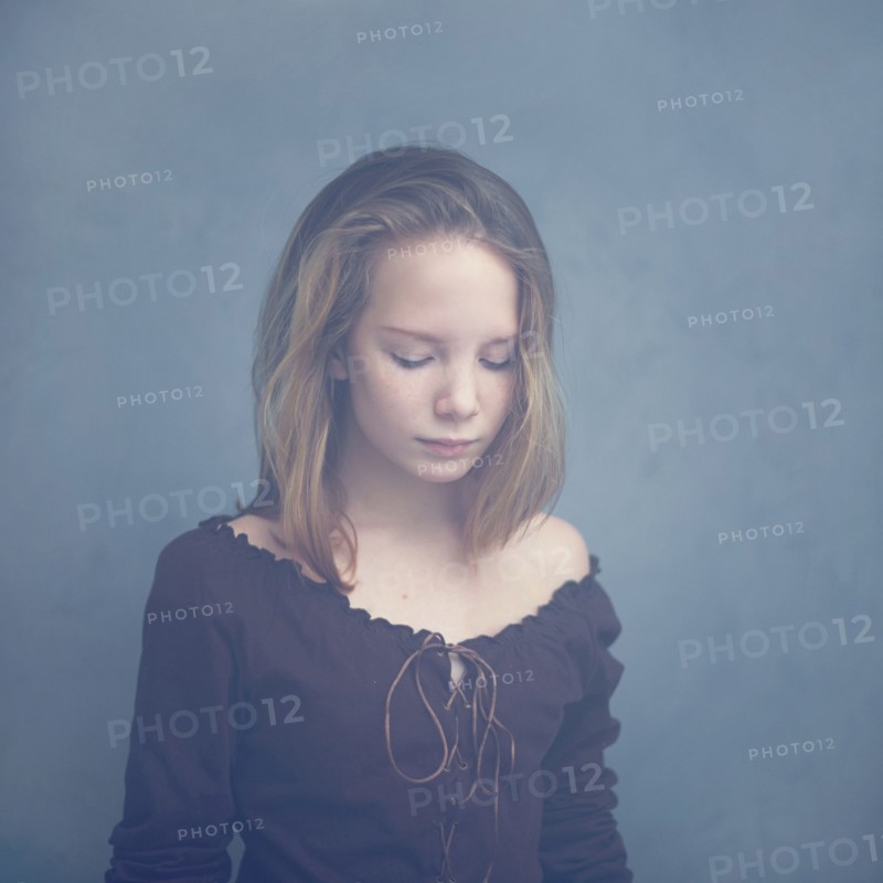 Caucasian teenage girl looking down