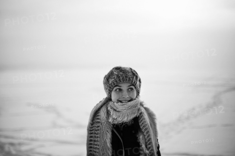 Caucasian teenage girl wearing scarf in snow