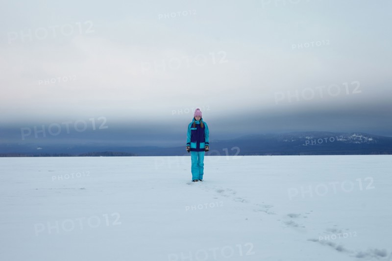 Caucasian teenage girl walking in snow