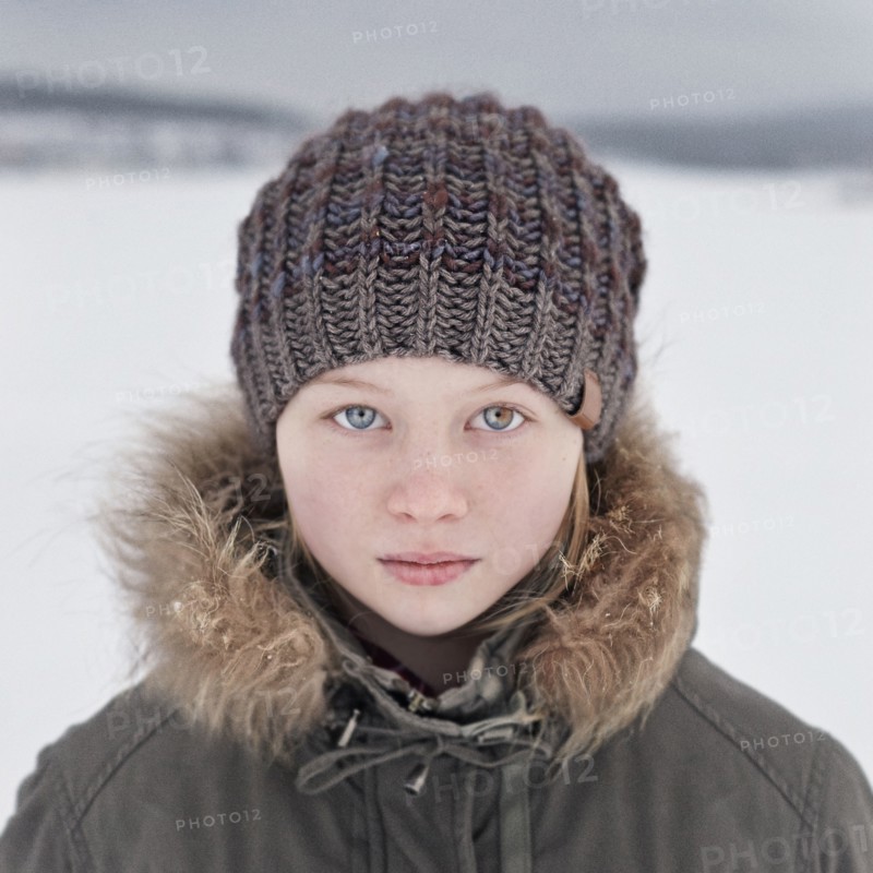 Caucasian teenage girl wearing beanie hat in snow