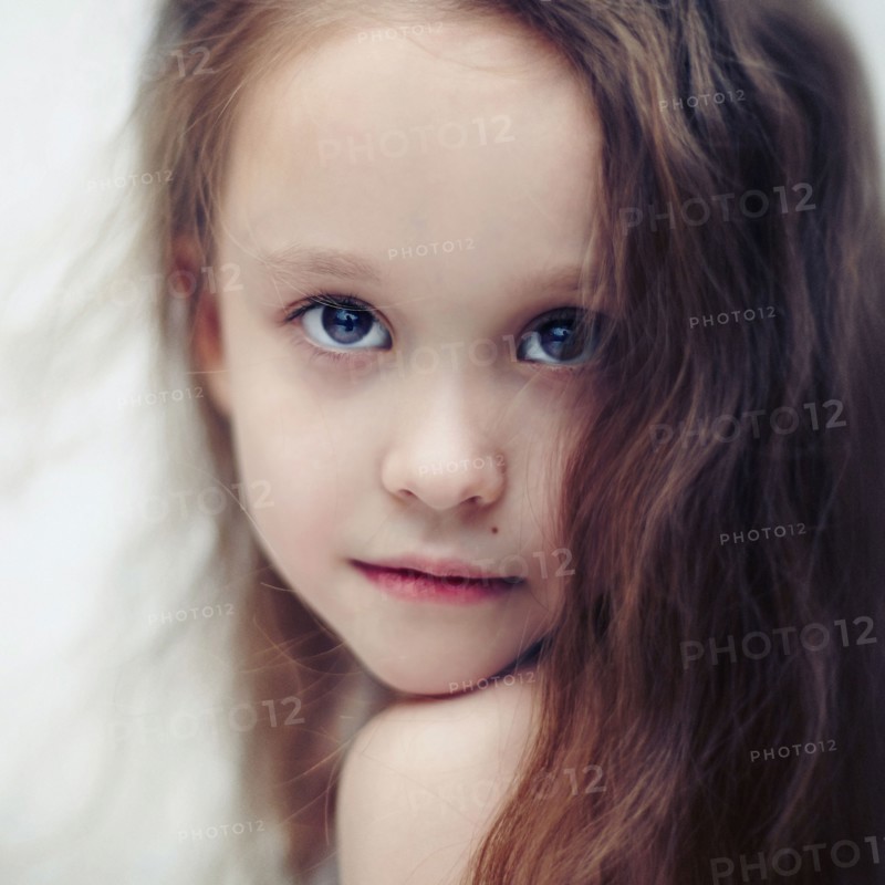 Caucasian girl looking over her shoulder
