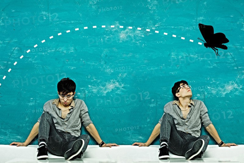 Double exposure of Caucasian man under butterfly
