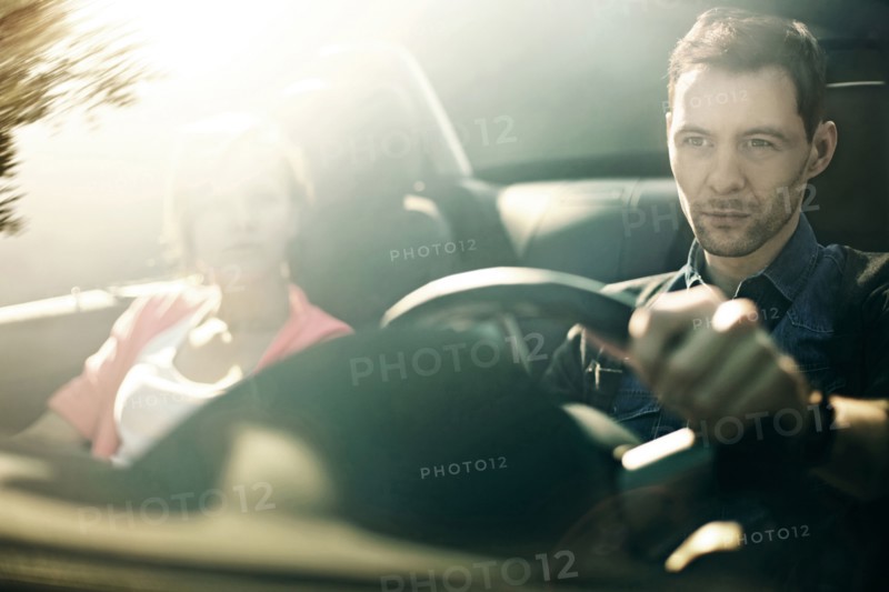 Caucasian father and daughter driving in car