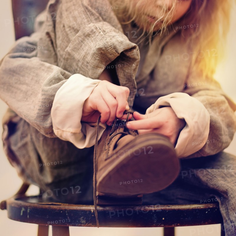Caucasian girl tying her shoe