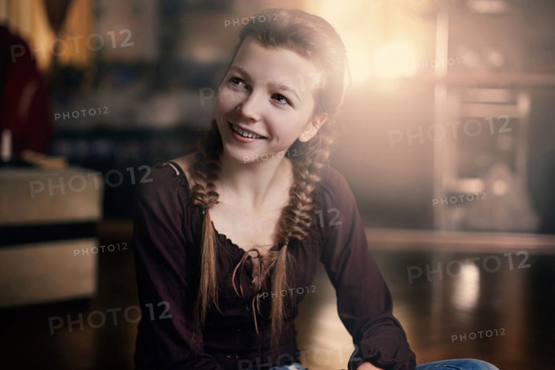 Caucasian teenage girl smiling indoors