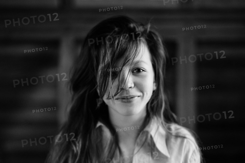 Caucasian teenage girl smiling indoors