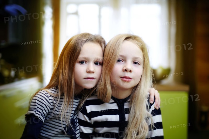 Caucasian girls sitting indoors