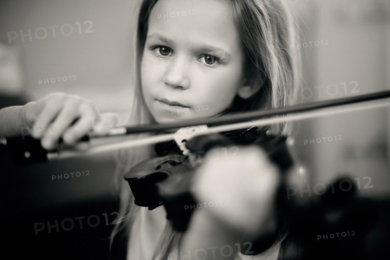Caucasian girl playing violin