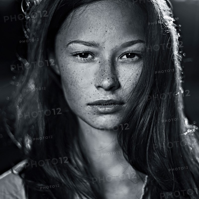 Serious Caucasian teenager with freckles