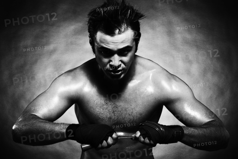 Caucasian boxer athlete flexing his muscles