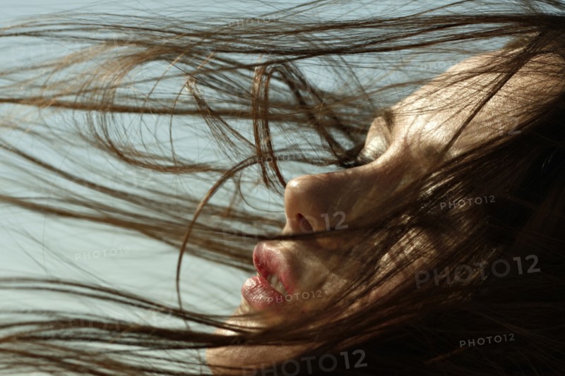 Caucasian woman with hair blowing in wind