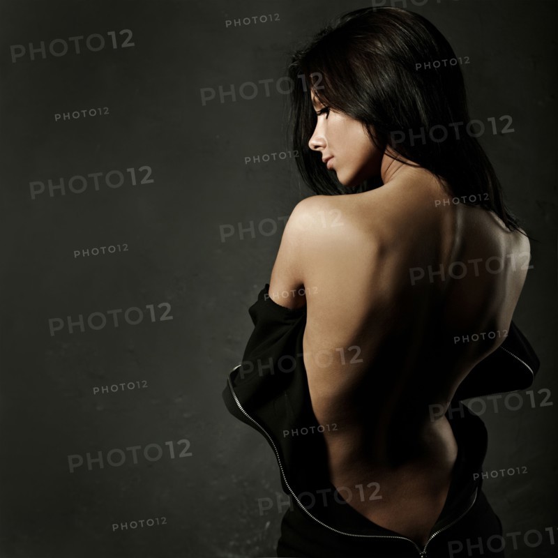 Caucasian woman exposing back in unzipped dress