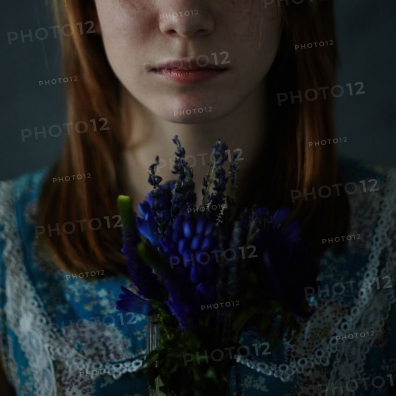 Caucasian teenage girl holding bouquet of flowers