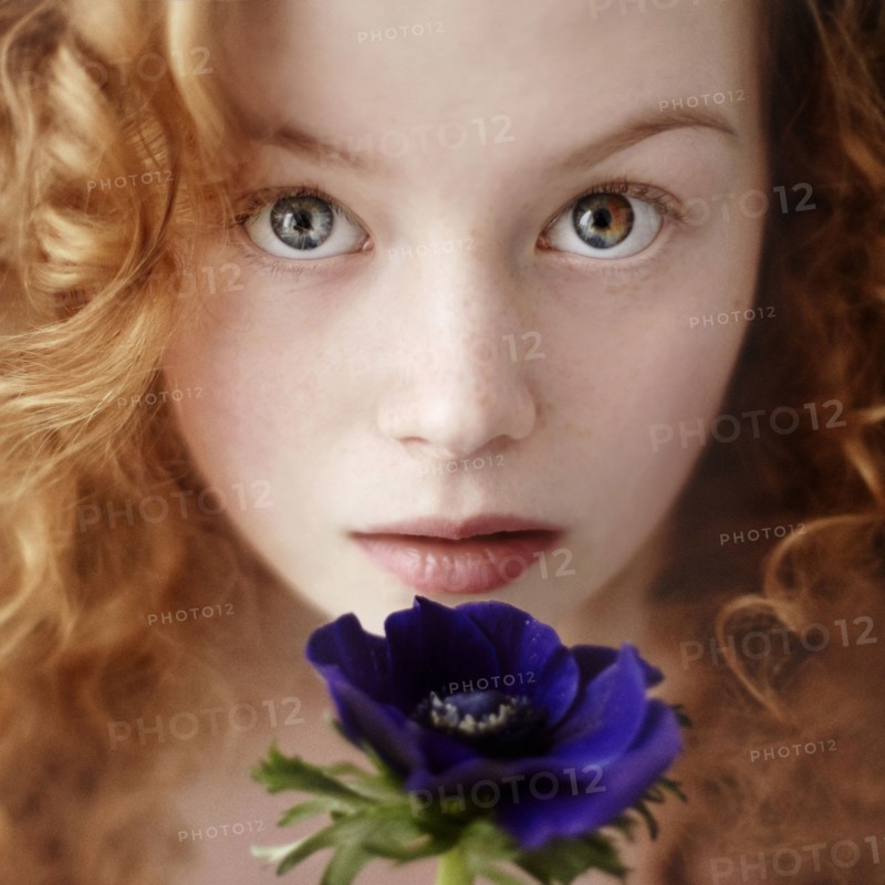 Caucasian teenage girl holding flower