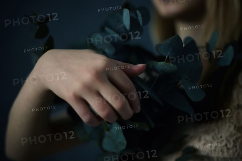 Caucasian teenage girl holding plants