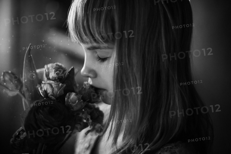 Caucasian teenage girl smelling flowers