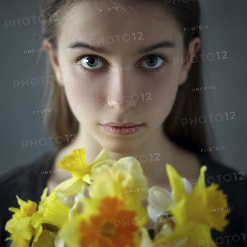 Caucasian girl holding yellow flowers
