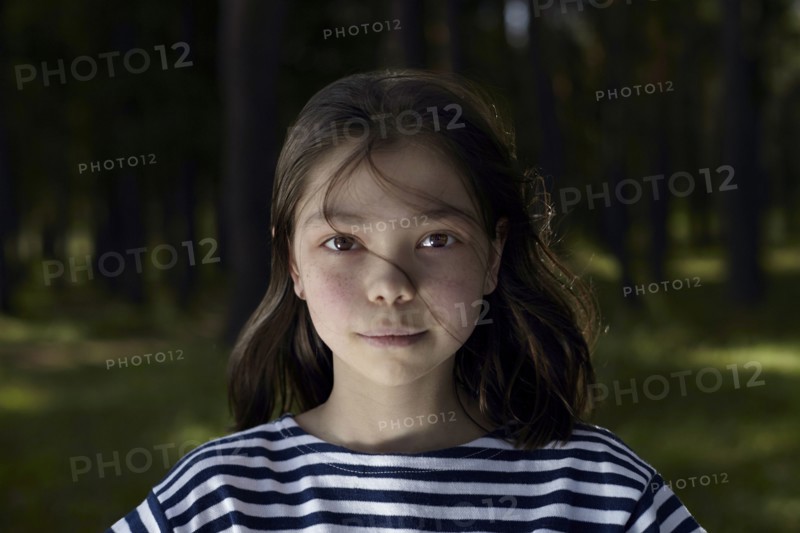 Serious Caucasian girl in forest
