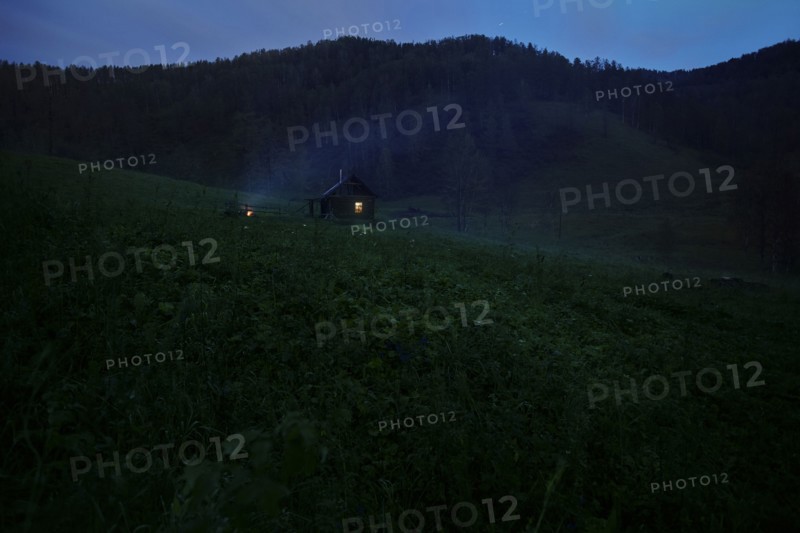 Distant house on hill at night