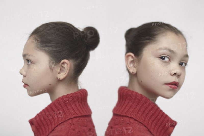 Twin Caucasian girls wearing red sweater