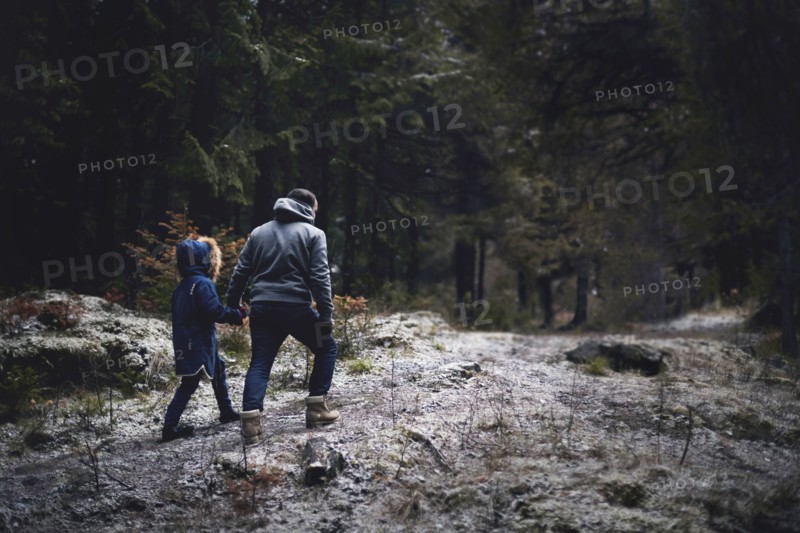 Caucasian father and daughter walking in woods