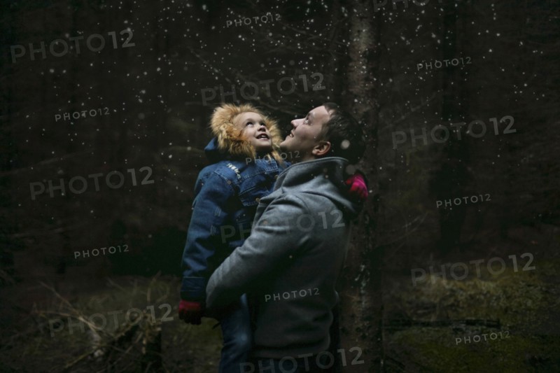 Caucasian father and daughter under starry sky
