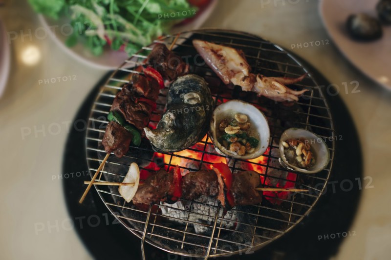 Seafood cooking on grille