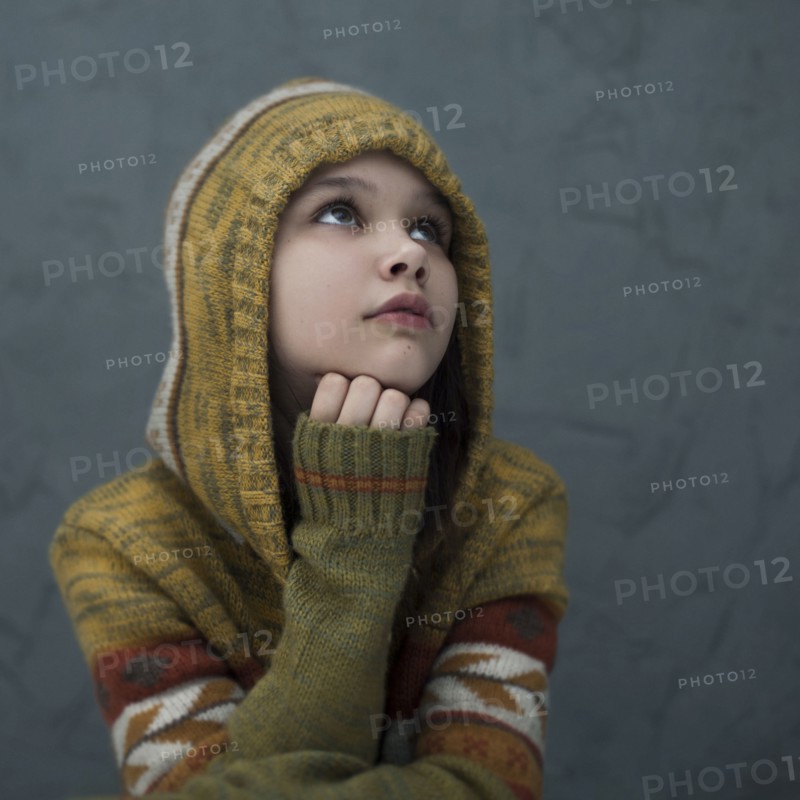 Pensive Caucasian girl wearing hood