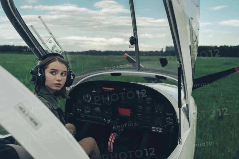 Caucasian woman sitting in airplane cockpit