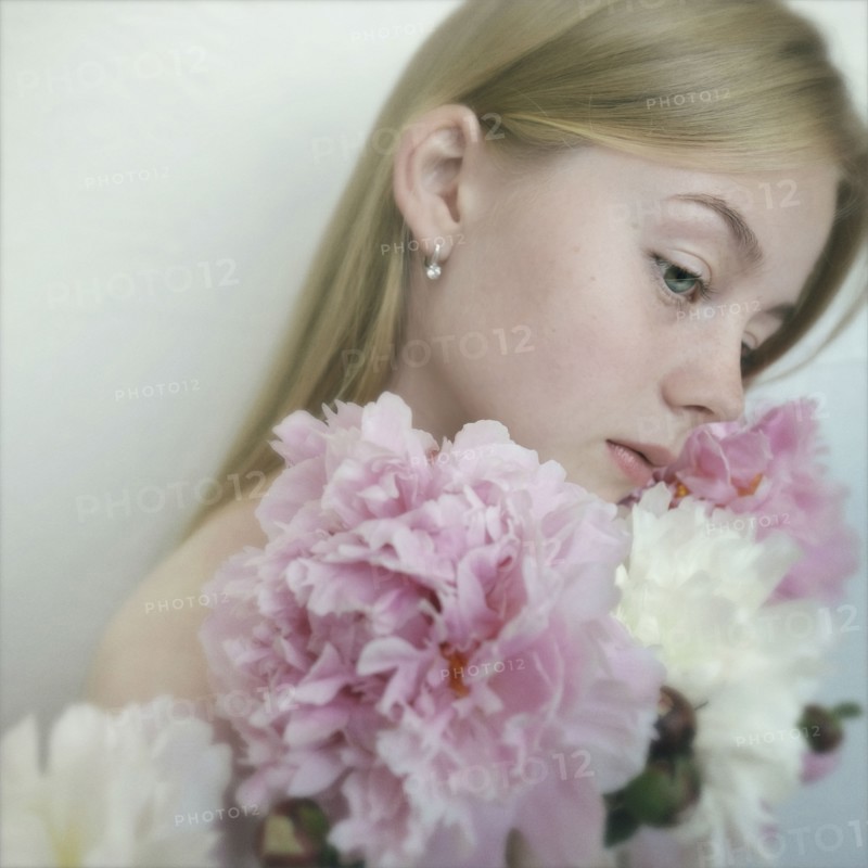 Close up of Caucasian teenage girl holding flowers