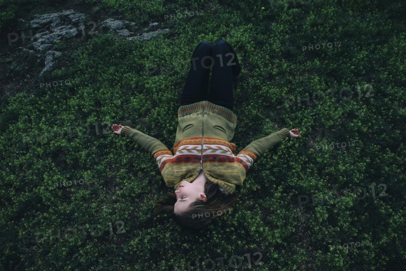 Caucasian woman laying in grass