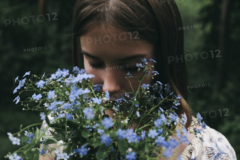 Caucasian woman smelling flowers