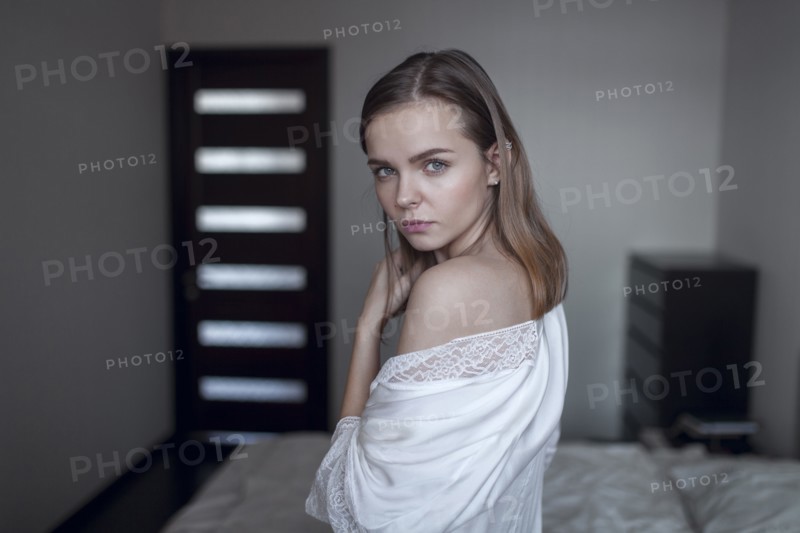 Portrait of serious Caucasian woman in bedroom