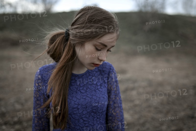 Wind blowing hair of pensive Caucasian woman
