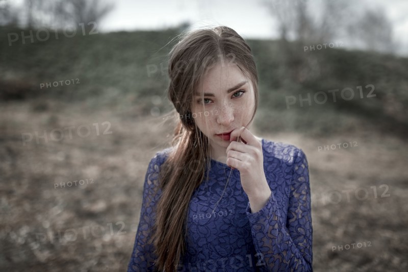 Wind blowing hair of curious Caucasian woman