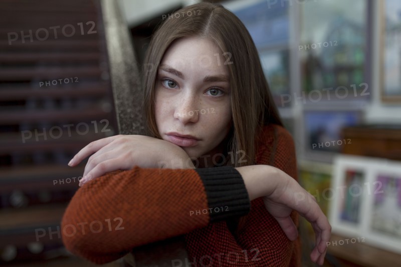 Caucasian woman leaning on staircase railing