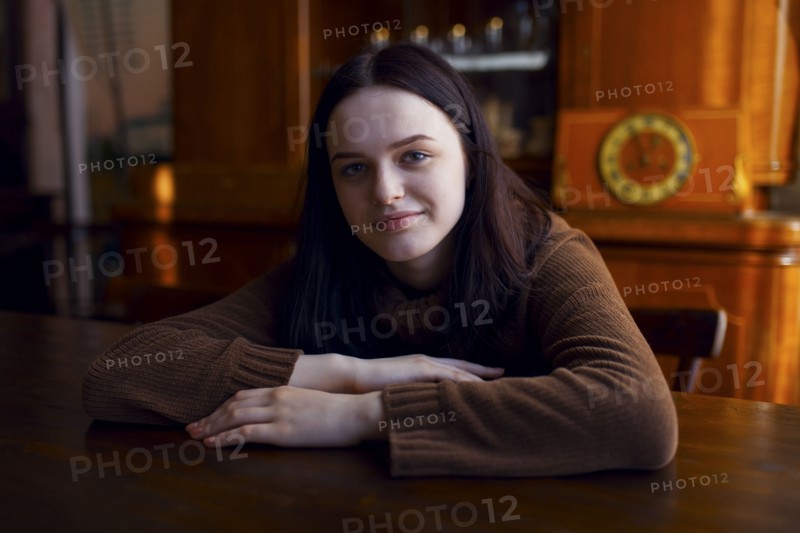 Smiling Caucasian girl sitting at table